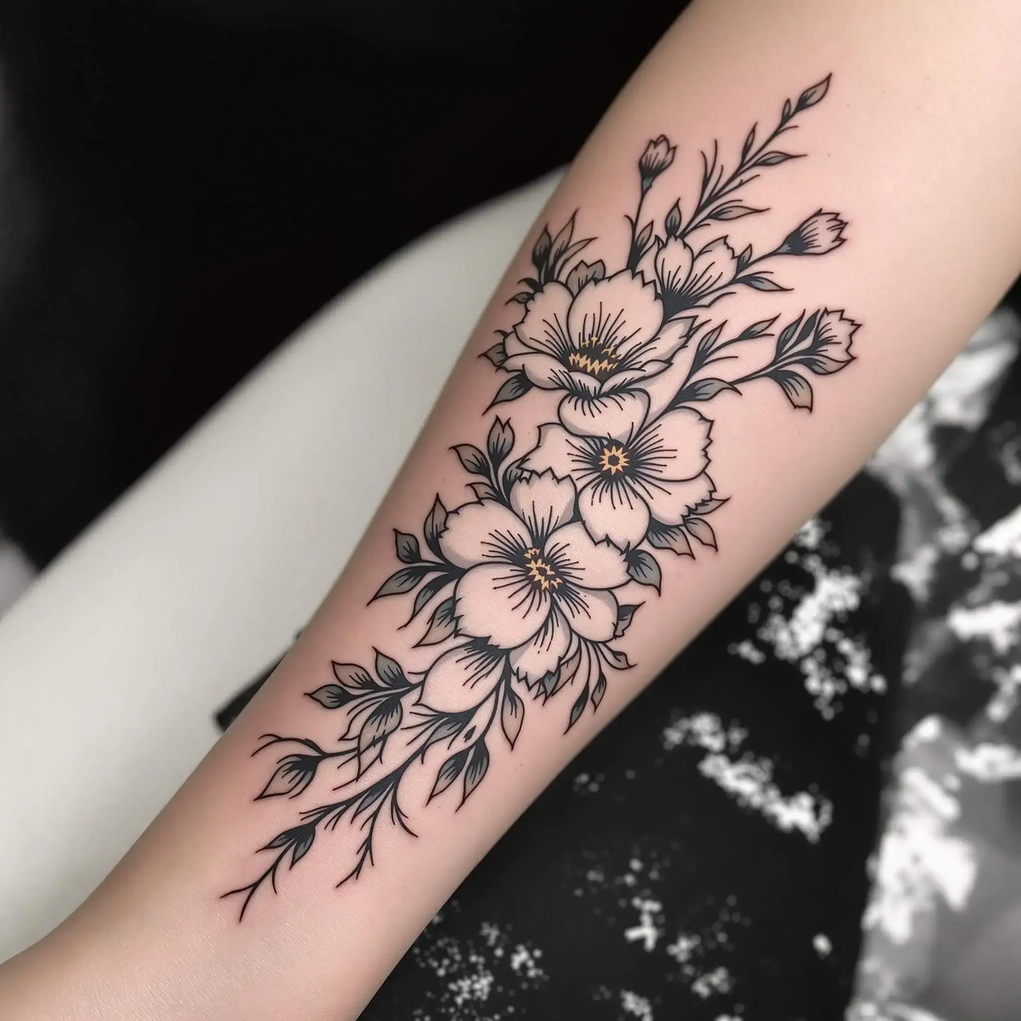 Flower tattoo wrapping forearm